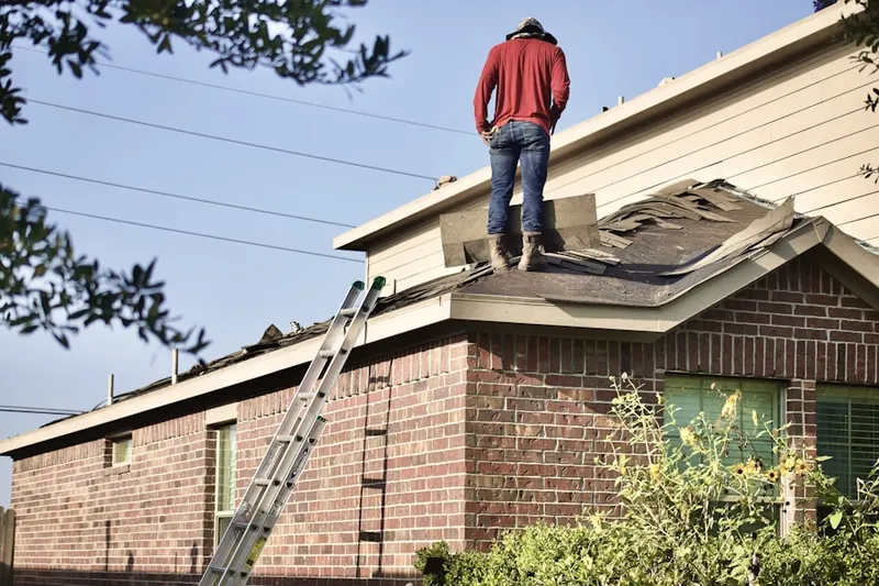 Professional roofer working on a residential roof in New Lexington